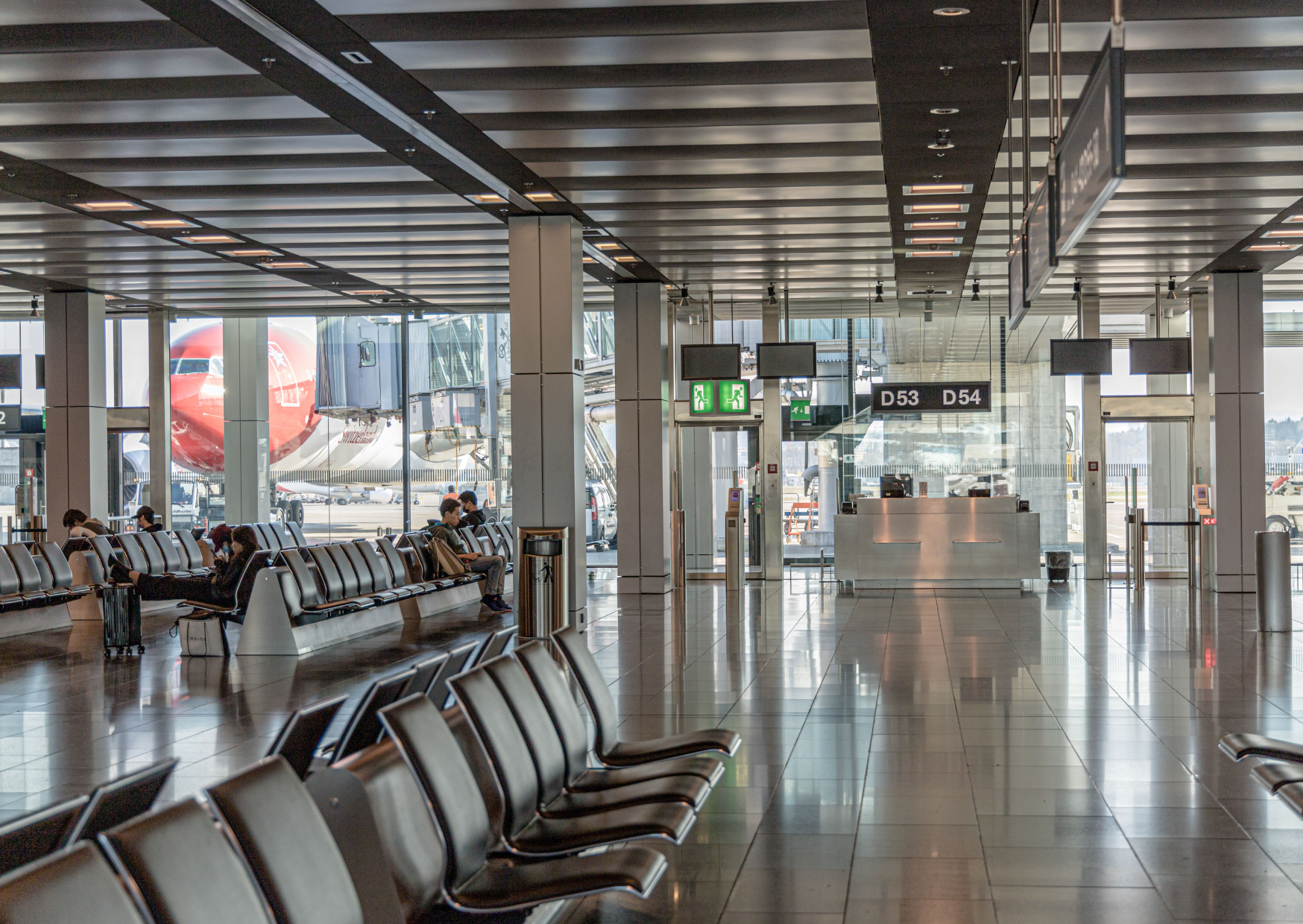 Modern airport lounge offering premium seating, dining and business facilities for travelers.