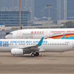 Passengers enjoying the Sky Bridge and modern terminal facilities at Hong Kong International Airport.