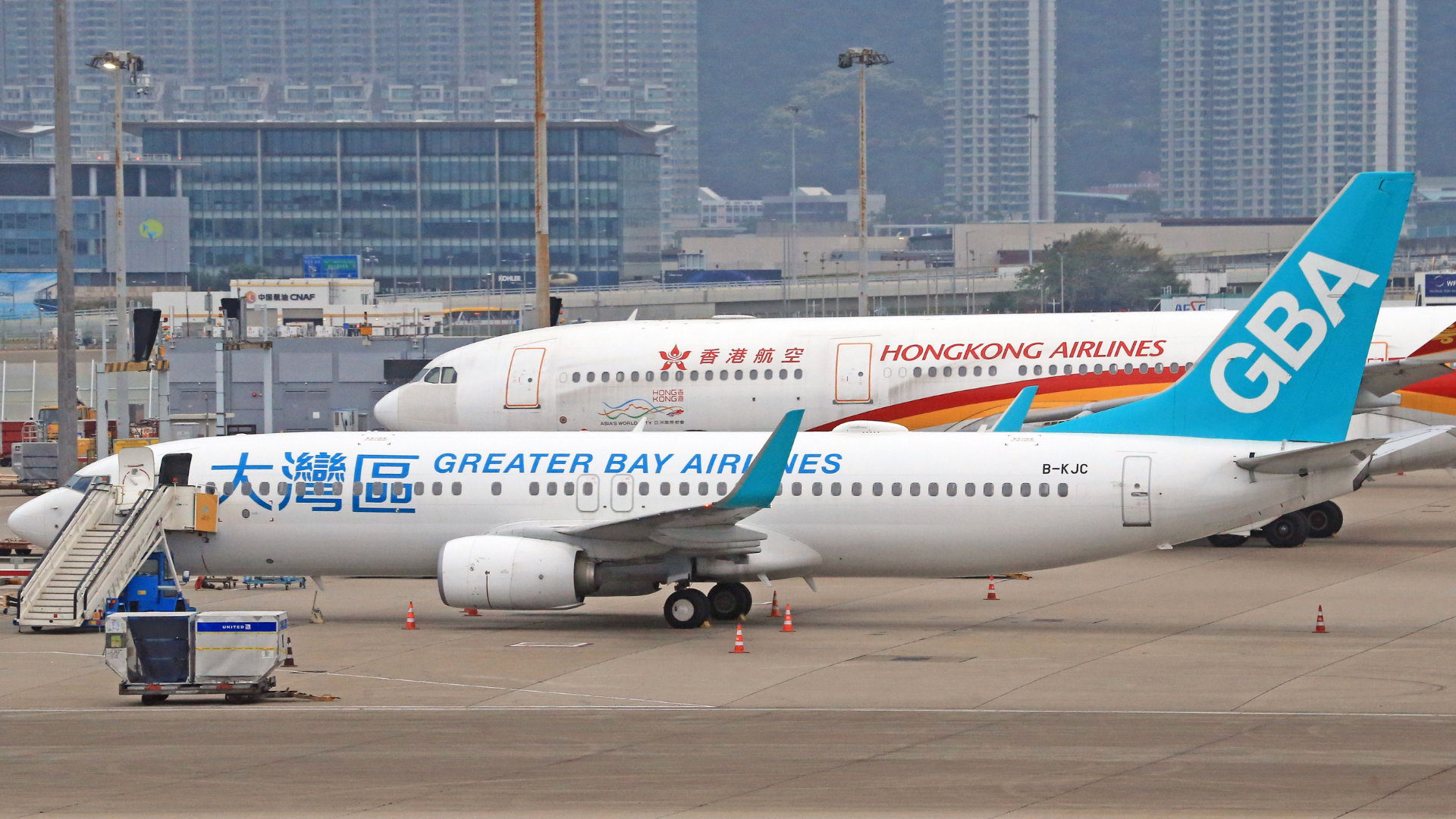 Passengers enjoying the Sky Bridge and modern terminal facilities at Hong Kong International Airport.